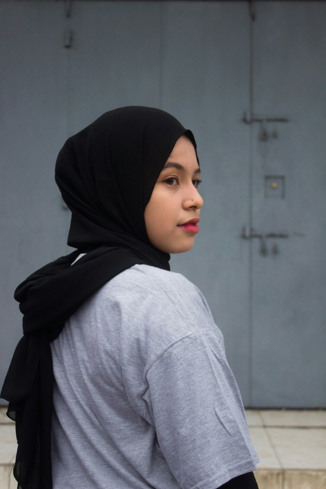 Portrait of a woman wearing a hijab and a light shirt