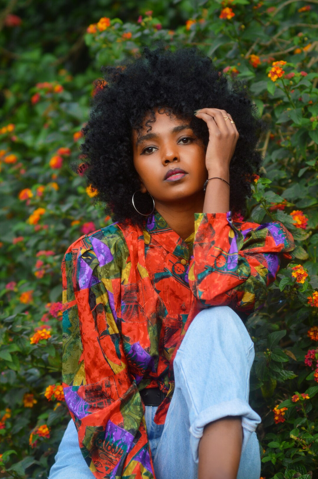 Portrait of a woman with short natural hair and a bright blouse