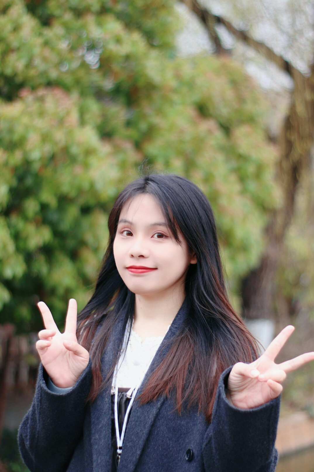 Portrait of a smiling woman with long dark hair in a blazer