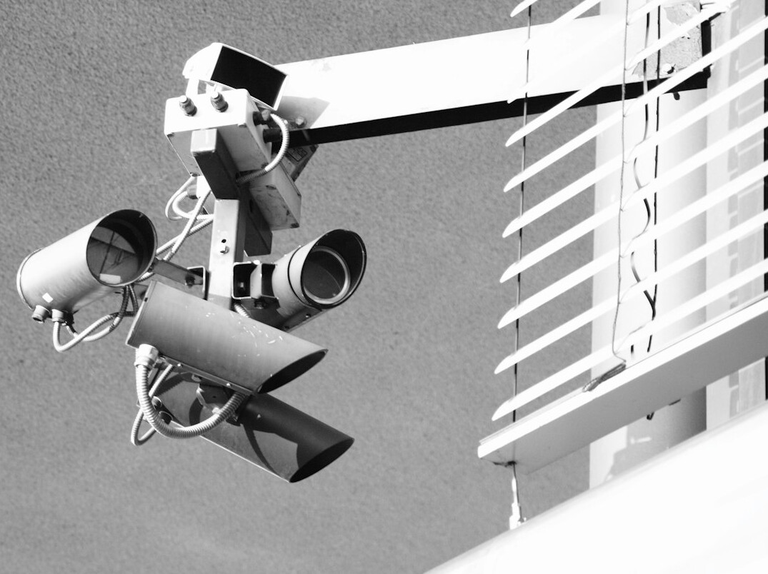 Live television studio with cameras on pedestals and bright studio lights